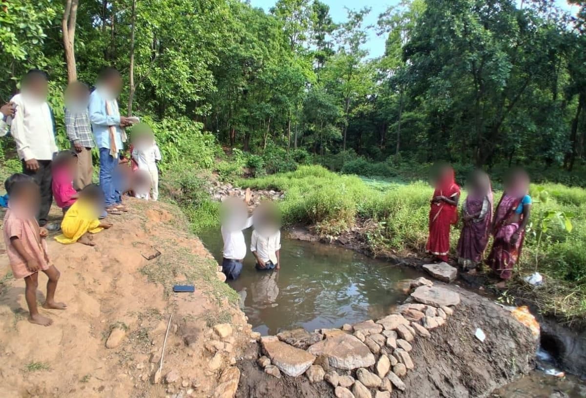 A village baptism in flowing water